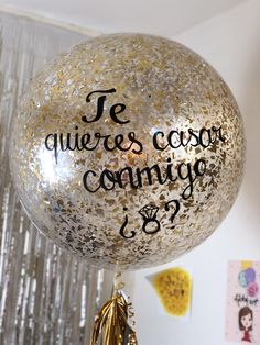 a balloon with confetti and writing on it