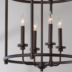 a chandelier with five lit candles hanging from it's center and four on each side