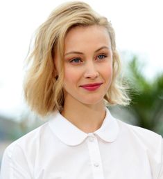 a woman with blonde hair wearing a white shirt