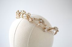 Lavishly designed with ethereal elements, our Antique gold crystal bridal tiara is sure to turn heads as you walk down the aisle. - Handcrafted with Premium European crystals and pearls- Each stone is set by hand in my studio- Golden shadow, ivory cream, white opal, clear stones, and crystal pearls- Antique gold finish- Tiara measures 15.5 inches x 1.25 inches- Handcrafted in the US.- Nickel free and hypoallergenic- PLEASE ALLOW APPORX 6-8 WEEKS FOR COMPLETIONThis is an original design by © Trea Simple Design Clothes, Wedding Jewelry Simple, Crown Aesthetic, Crystal Bridal Tiaras, Golden Shadow, Walk Down The Aisle, Queen Aesthetic, Pearl Tiara, Headpiece Jewelry