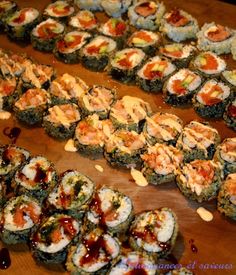 several sushi rolls are lined up on a table