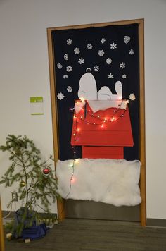 the door is decorated with christmas lights and a snoopy sleigh on it