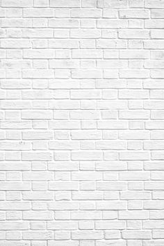 a white brick wall with a red fire hydrant