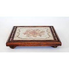 a wooden box with a floral design on it