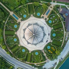 an aerial view of a circular garden in the middle of a road