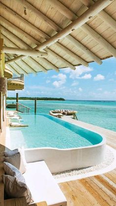 an outdoor swimming pool next to the ocean