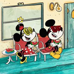 two mickey mouses are sitting at a table eating watermelon and drinking juice