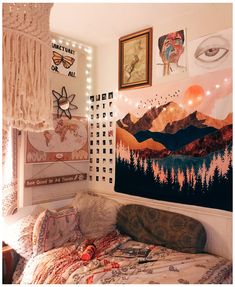 a bedroom with pictures on the wall and lights hanging above it, along with an unmade bed