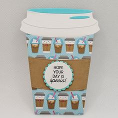 a coffee cup with a blue lid and some paper around it that says hope your day is special