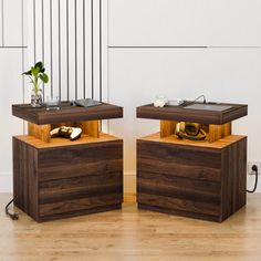 two side tables that are made out of wood and have speakers on top of them