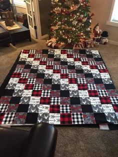 a christmas tree is next to a black and white quilt