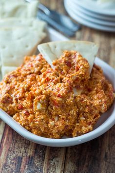 a white bowl filled with cheese and crackers