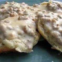 biscuits and gravy on a blue plate with broccoli