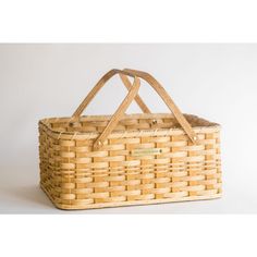 a woven basket sitting on top of a white table