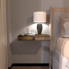 a nightstand with a lamp on it next to a bed