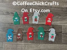 cross stitch christmas decorations are displayed on a wooden surface with the words coffee chick crafts on it