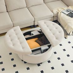 a white couch sitting on top of a living room floor