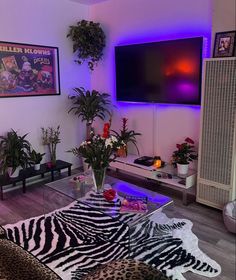 a living room filled with furniture and a flat screen tv mounted to the side of a wall