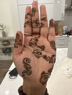 a woman's hand with hendi designs on it