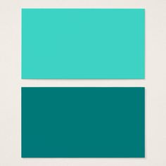 two different shades of teal green on white paper, one is blue and the other is