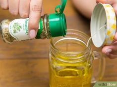 a person is pouring mustard into a jar