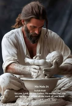 a man that is sitting down with a bowl in his hand and a statue behind him