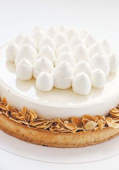 a white cake topped with marshmallows and nuts