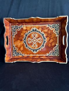 a wooden tray with an ornate design on it