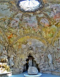 an artisticly painted ceiling with statues in it