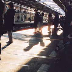 people are waiting for the train at the station