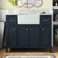 a bathroom with a sink, mirror and rug