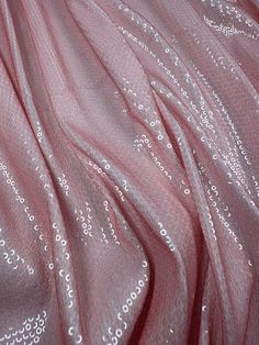 What is Sequin Fabric? ( Width: 140 cm / 1.53 yards / 55.12 inches ) Sequin fabric, also known as sequin or glitter fabric, is a type of textile adorned with small, shiny discs called sequins. These sequins are typically made from plastic, metal, or other reflective materials, and are sewn or adhered onto the fabric to create a dazzling, sparkling effect. Sequin fabric is highly favored for its glamorous appearance and is often used in fashion and design to add a touch of sparkle and luxury. Use Luxury Elegant Holiday Sequin Fabric, Clothing Texture, Pink Fabrics, Highly Favored, Types Of Textiles, Sequins Fabric, Soft Pink Color, Fabric Sewing, Glitter Fabric