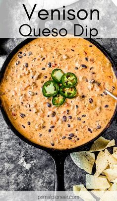 a skillet filled with quesadilla dip and topped with sliced jalapenos