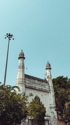 a tall white building with two towers on top