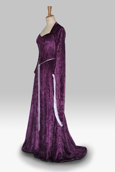 "Medieval Dress, Pagan Dress, Elvish Dress, Pre-Raphaelite Dress, Renaissance Gown, Medieval Wedding Dress, Hand Fasting Dress, \"Coleen\".  Coleen, elegant in  purple crushed velvet is designed and custom made by Gill Linley of frockfollies. The romantic and flattering sweetheart neckline shape is echoed by the twisted silk belt at the waist/top hip. The inner sleeves are lined in lilac on this occasion. Perfect for so many occasions: Medieval, Renaissance, Elvish Weddings, Hand Fasting ceremonies, LARP events, Re Enactments, Masquerade Balls or your 'inner goddess' moments!  Hand made in England by an experienced theatrical costumier, this medieval gown is available to order in a wide choice of colors and will be custom made to your measurements. frockfollies prides itself on quality of Elven Style Wedding Dress With Historical Design, Elven Wedding Dress With Historical Design, Elven Style Fitted Floor-length Dress, Elvish Medieval Dress For Weddings And Festivals, Elvish Medieval Wedding Dress For Medieval Festivals, Purple Fantasy Dresses For Fantasy Events, Historical Design Dresses With Fitted Bodice For Cosplay, Gothic Floor-length Dress For Medieval Festivals, Medieval Style Floor-length Dress For Fancy Dress