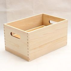 a wooden box with holes in it on a white tableclothed background and the bottom section is made out of plywood