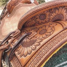 the back end of a saddle with sunflowers on it