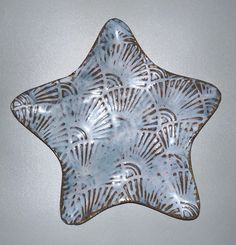 a star shaped glass plate with designs on it