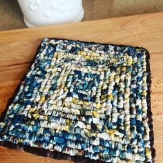 a close up of a rug on a wooden table