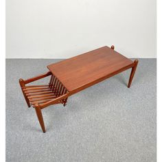 a wooden coffee table sitting on top of a carpeted floor