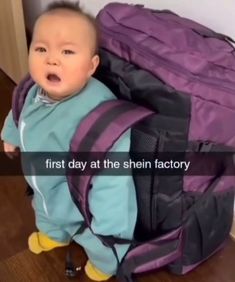 a baby is standing in front of a purple backpack with the words first day at the shin factory