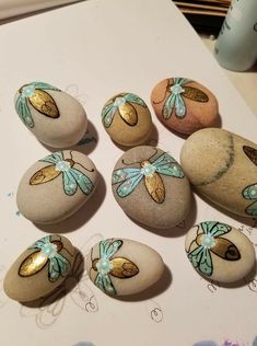 six painted rocks sitting on top of a table