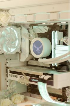 the inside of a computer case with flowers and other things on it's shelves