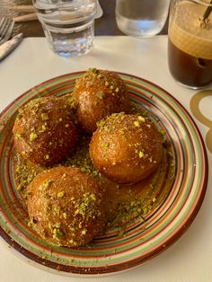 some food is sitting on a plate on a table with water glasses and utensils