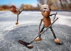 a toy figure is skating on an ice rink with one foot in the air and two legs out