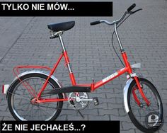 a red bicycle with the words tylko nie mow on it