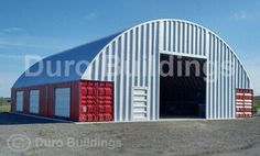 a large metal building with red and white doors