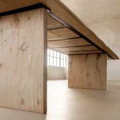 an empty room with wooden beams on the ceiling