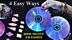 two cds are being held up to show how to cut cd disks with scissors and tape