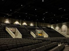 an empty auditorium filled with black seats